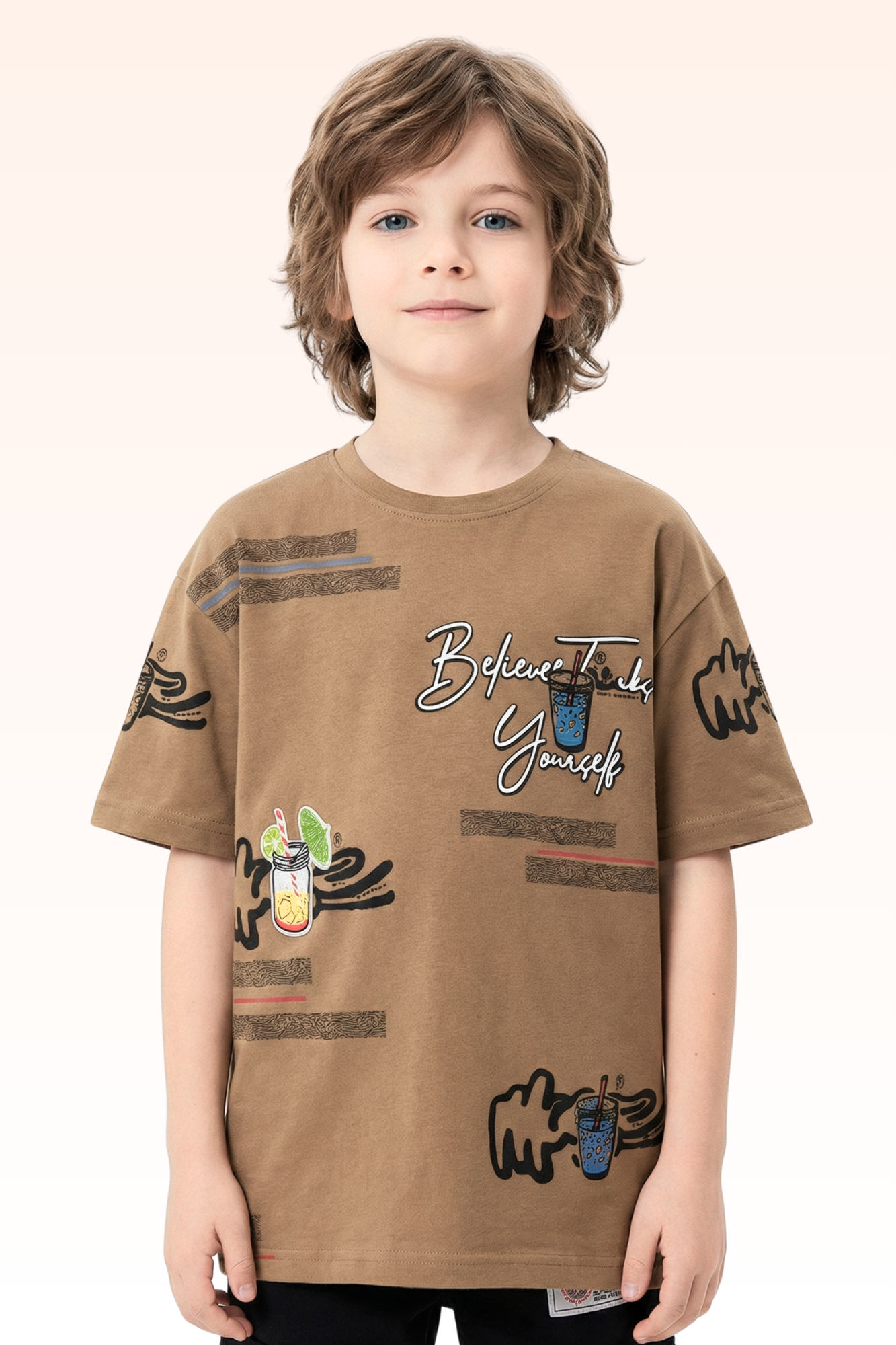 Child wearing a brown t-shirt with various designs and text on a beige background